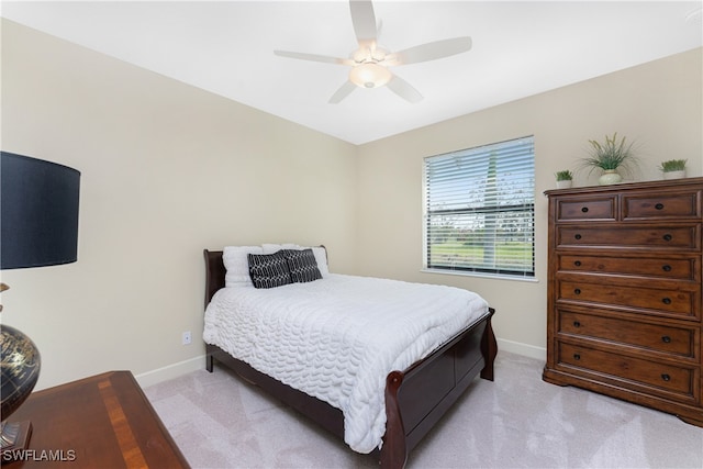 bedroom featuring light carpet and ceiling fan