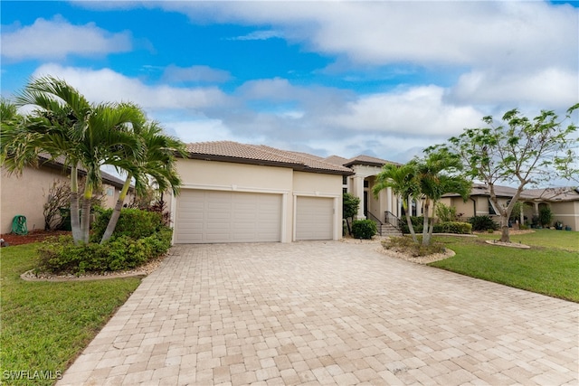 mediterranean / spanish-style house with a garage and a front yard