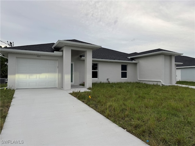 view of front of house featuring a garage and a front yard