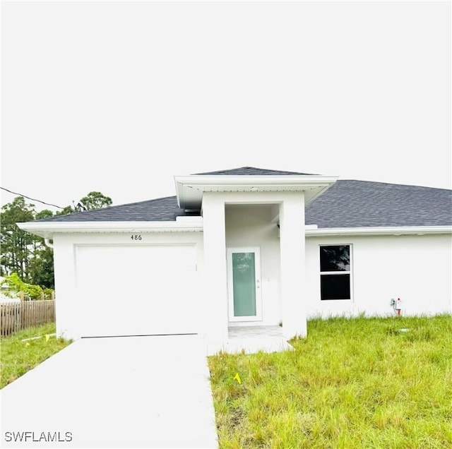 rear view of house featuring a garage