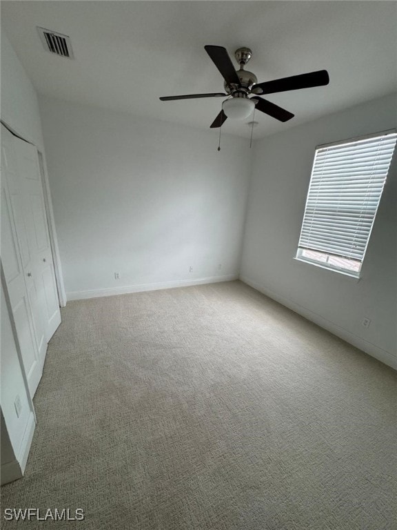 carpeted empty room with ceiling fan