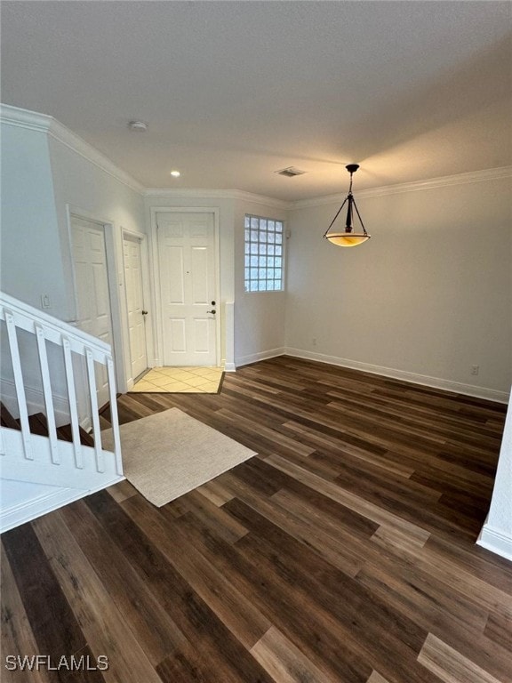 interior space with dark hardwood / wood-style flooring and crown molding