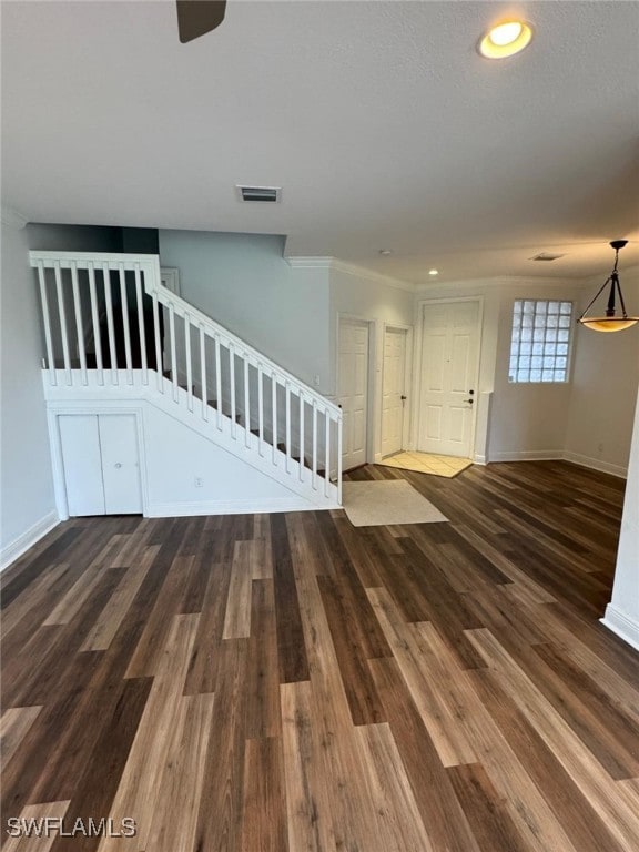 interior space with dark hardwood / wood-style flooring and crown molding