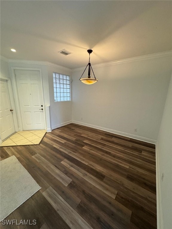 interior space featuring ornamental molding and dark hardwood / wood-style floors