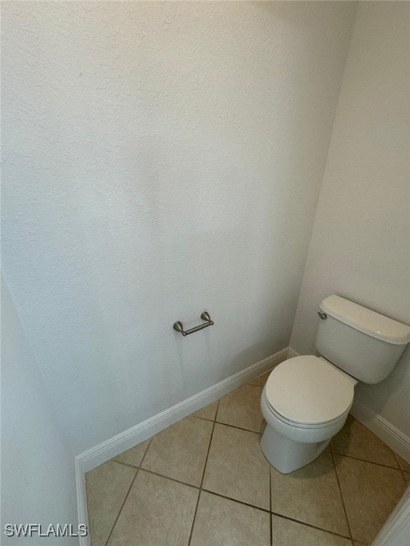 bathroom featuring tile patterned floors and toilet