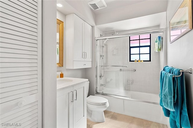 full bathroom featuring vanity, bath / shower combo with glass door, and toilet