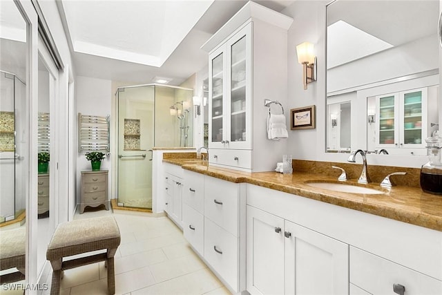 bathroom featuring vanity, tile patterned flooring, and a shower with shower door