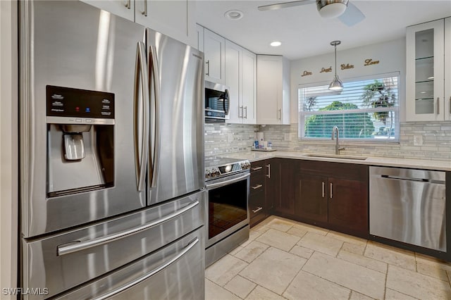 kitchen featuring tasteful backsplash, stainless steel appliances, ceiling fan, sink, and white cabinets