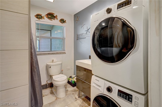 clothes washing area with stacked washer and clothes dryer