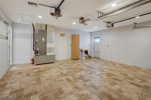 garage with ceiling fan and a garage door opener