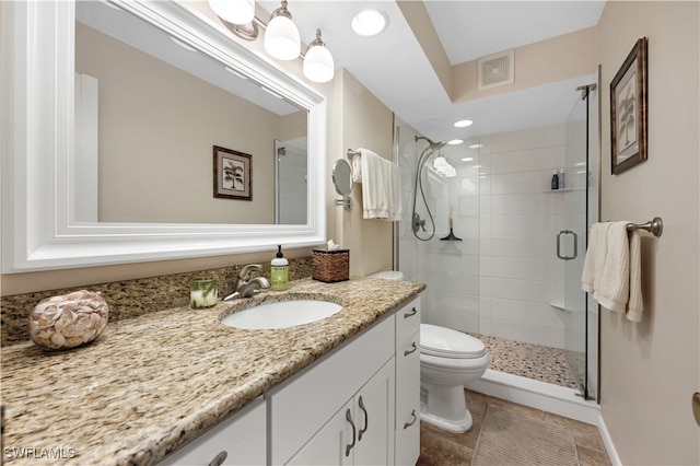 bathroom featuring walk in shower, vanity, and toilet