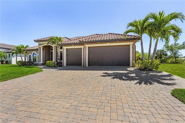 mediterranean / spanish-style house with a front yard and a garage