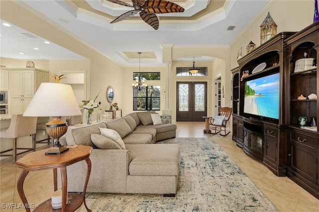 living room featuring ceiling fan with notable chandelier, crown molding, a tray ceiling, and french doors