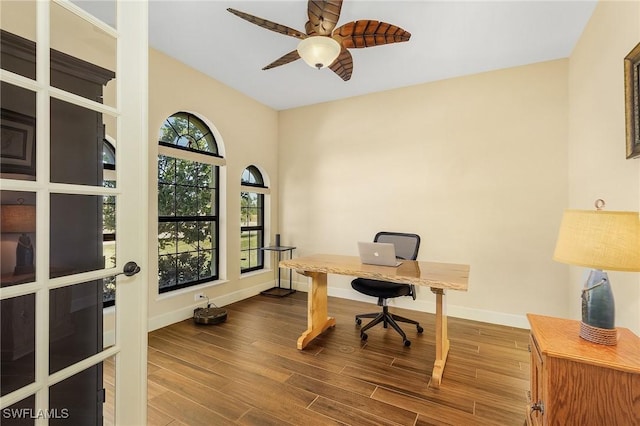 home office with hardwood / wood-style floors and ceiling fan