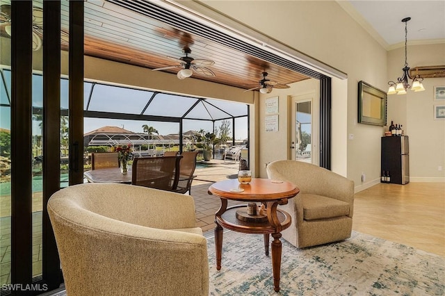 interior space with ceiling fan with notable chandelier and wooden ceiling