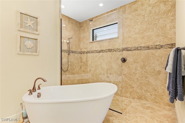 bathroom featuring shower with separate bathtub