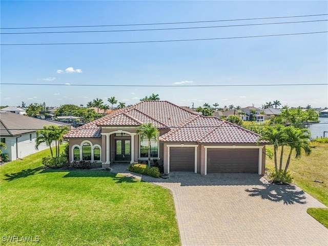 mediterranean / spanish-style home featuring a garage and a front yard