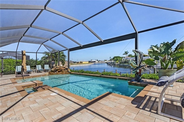 view of swimming pool with a water view, glass enclosure, and a patio area