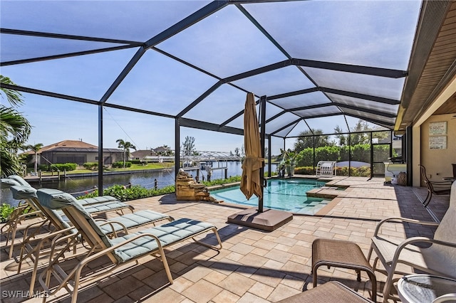 view of patio / terrace with a water view, a dock, and a lanai