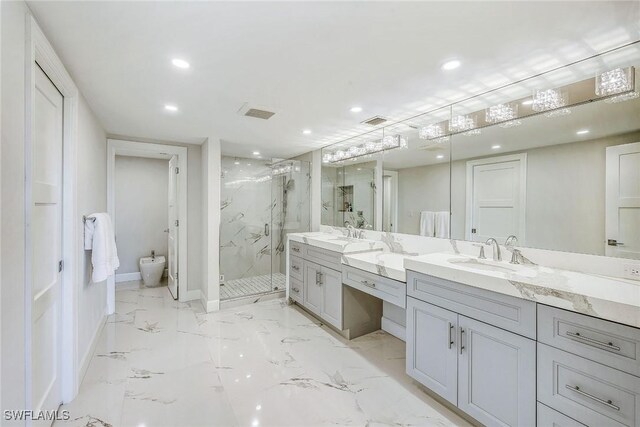 bathroom featuring a bidet, a shower with shower door, and vanity