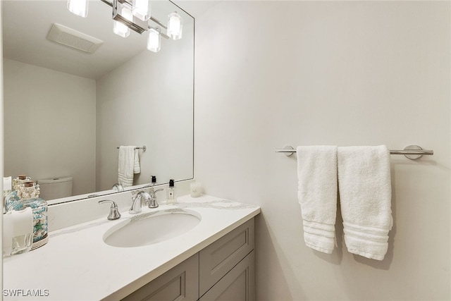 bathroom with toilet and vanity