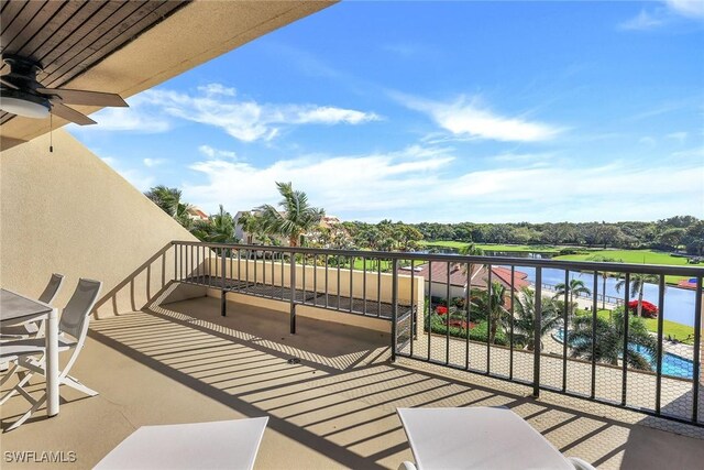 balcony featuring a water view and ceiling fan