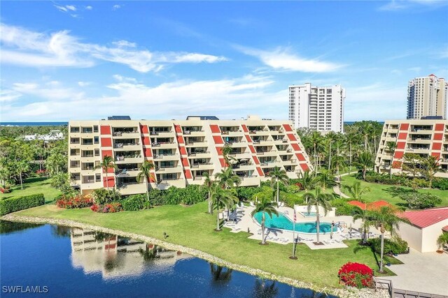 view of property with a water view and a community pool