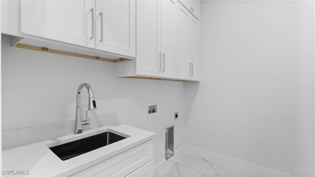 washroom with hookup for an electric dryer, hookup for a washing machine, cabinets, and sink