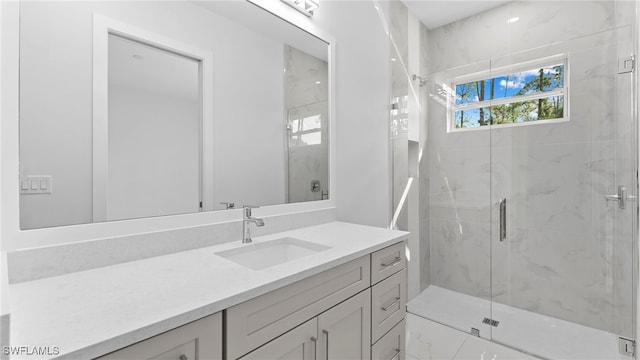 bathroom featuring vanity and a shower with shower door