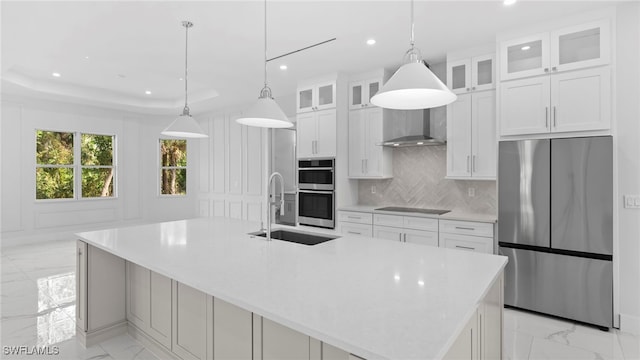 kitchen featuring a spacious island, white cabinetry, sink, and stainless steel appliances