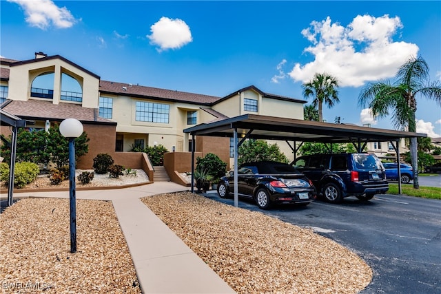 view of parking / parking lot featuring a carport