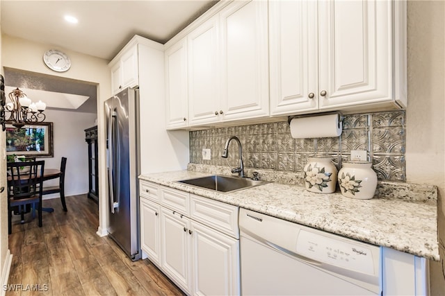 kitchen featuring stainless steel fridge, dark hardwood / wood-style floors, sink, white cabinets, and dishwasher