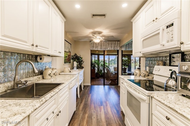 kitchen featuring dark wood-type flooring, white cabinets, sink, ceiling fan, and white appliances