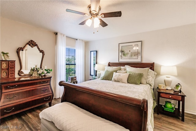 bedroom featuring hardwood / wood-style floors, ceiling fan, and a textured ceiling