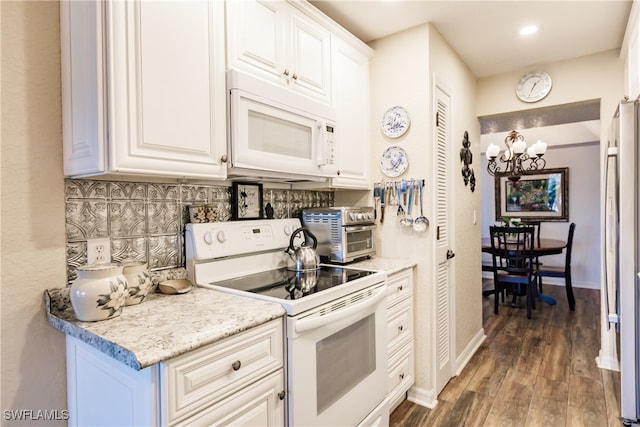 kitchen with tasteful backsplash, white cabinetry, a notable chandelier, dark hardwood / wood-style flooring, and white appliances