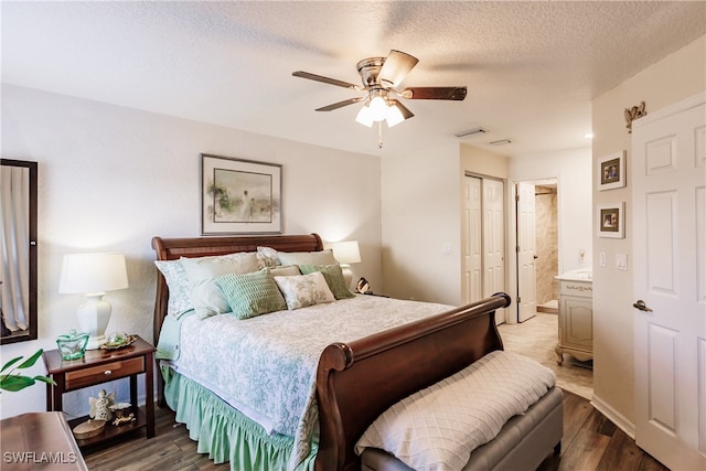 bedroom with dark hardwood / wood-style floors, ceiling fan, a textured ceiling, connected bathroom, and a closet