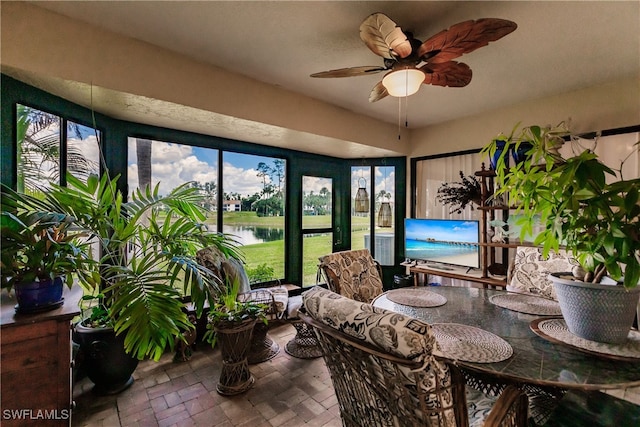 sunroom / solarium featuring a wealth of natural light and ceiling fan