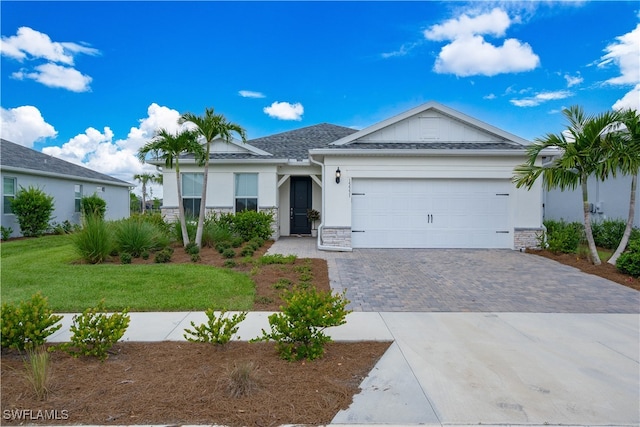 ranch-style house with a garage and a front lawn