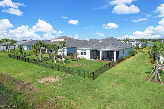 back of house with a lawn and a sunroom