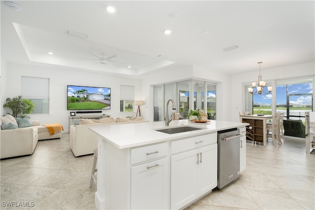 kitchen with a center island with sink, white cabinetry, hanging light fixtures, sink, and dishwasher