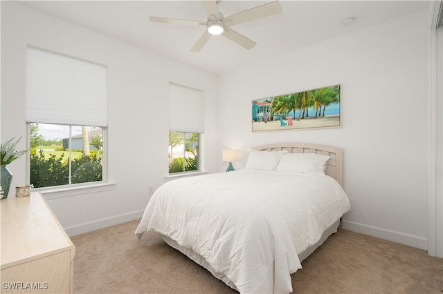 bedroom featuring ceiling fan and light colored carpet