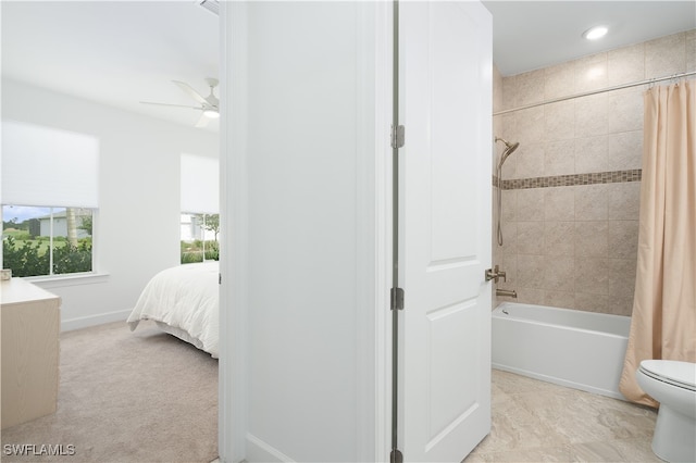 bathroom featuring toilet, shower / bath combination with curtain, and ceiling fan