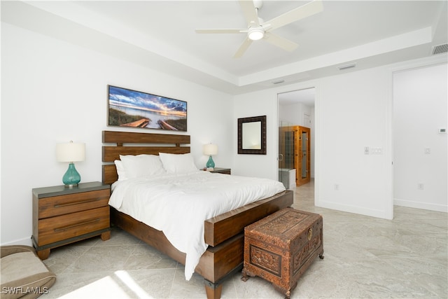 bedroom featuring ceiling fan and a raised ceiling