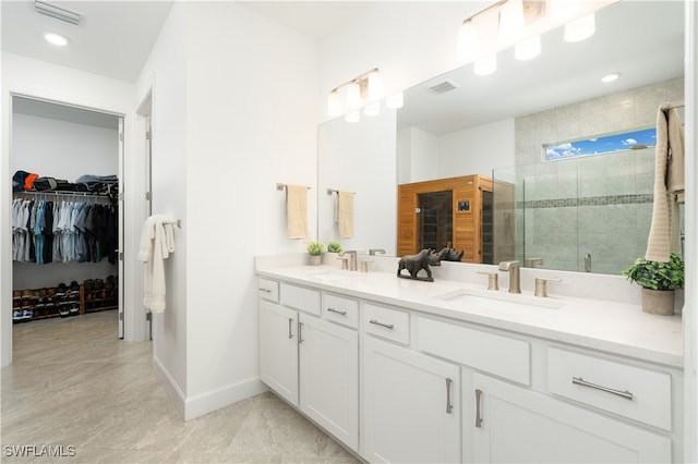 bathroom with vanity and a shower with door