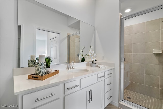 bathroom with walk in shower and vanity