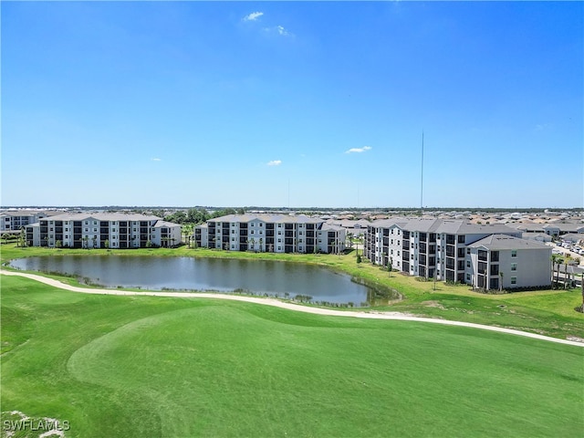 exterior space featuring a lawn and a water view