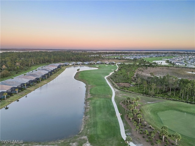 aerial view at dusk featuring a water view