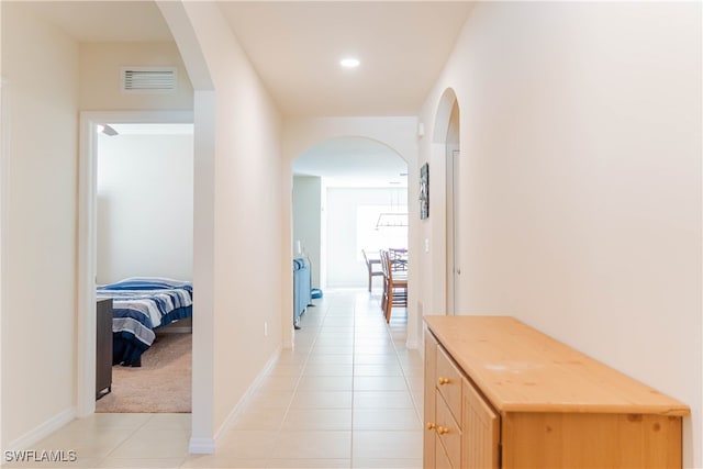 hall with light tile patterned floors