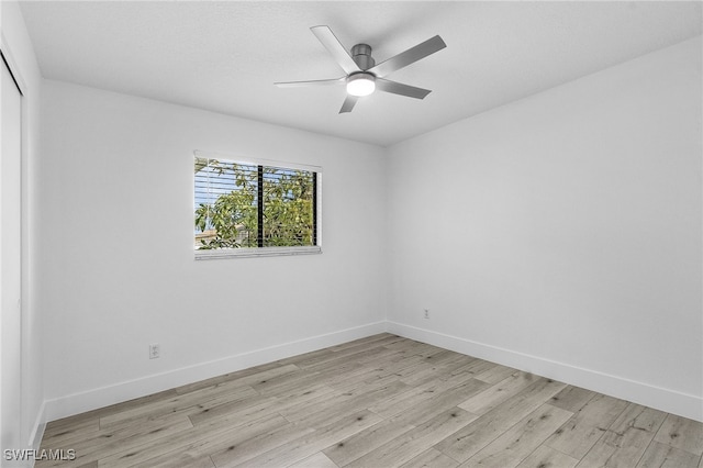 spare room with light hardwood / wood-style floors and ceiling fan