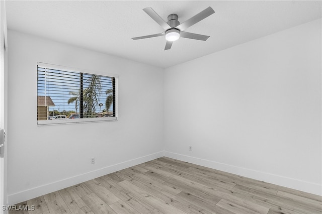 spare room with light wood-type flooring and ceiling fan